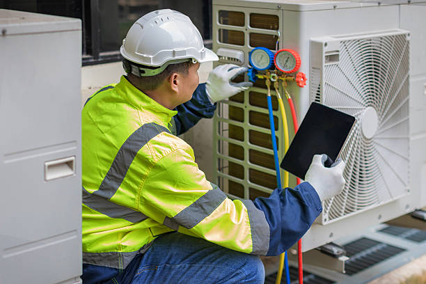 Professional Ductwork Repair technician working in Champaign, IL